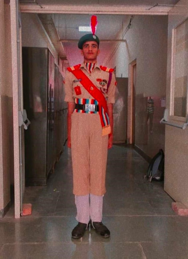 Cadet standing at attention in full parade dress uniform