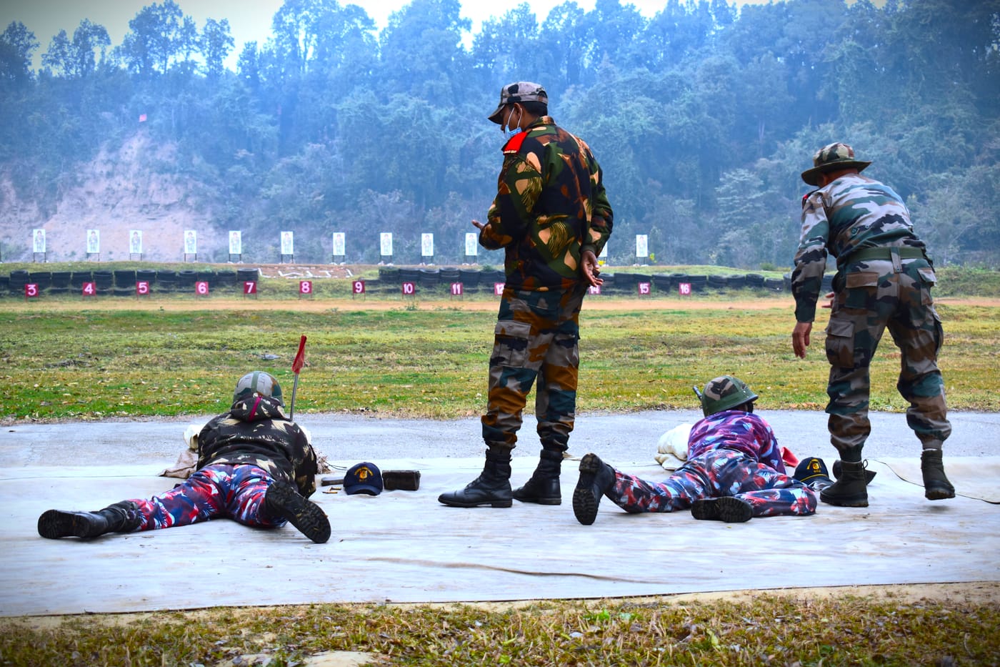 Cadets in prone position on a firing range under instruction