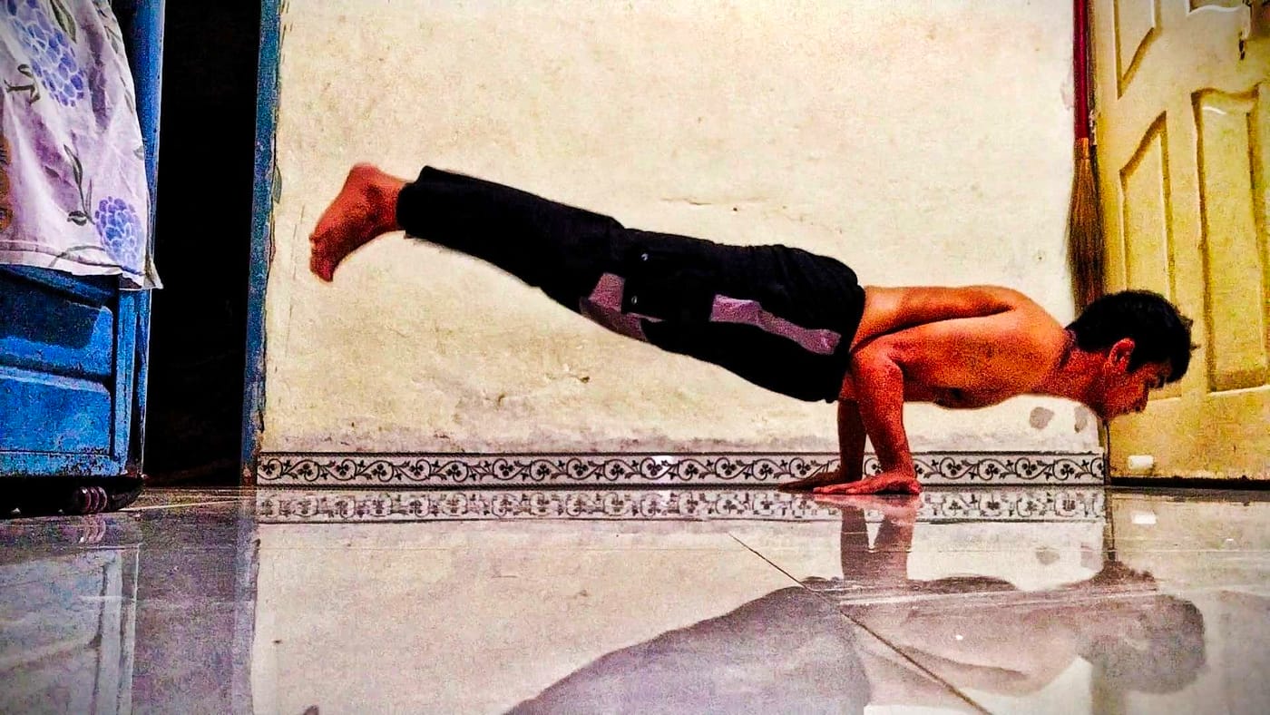 Planche hold on a tiled floor — a straight-arm strength exercise